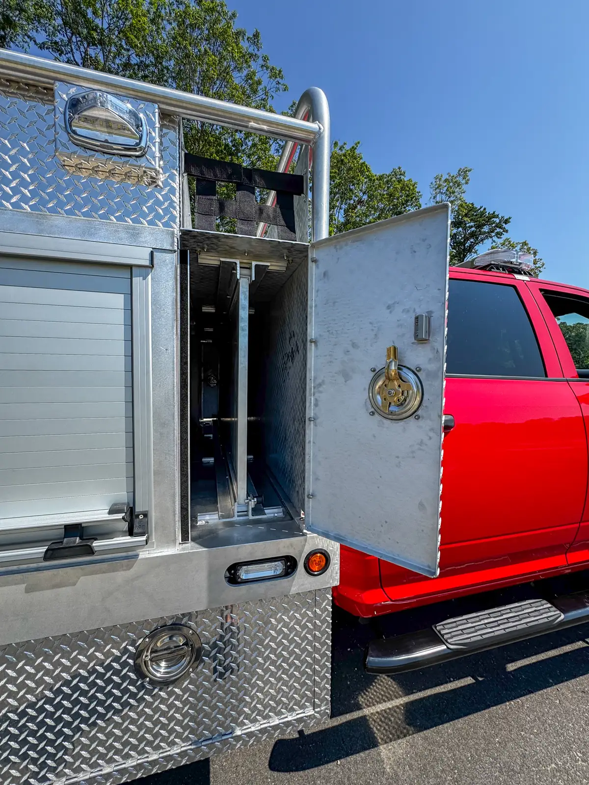 Open long side storage door on right body showing full-length bay.